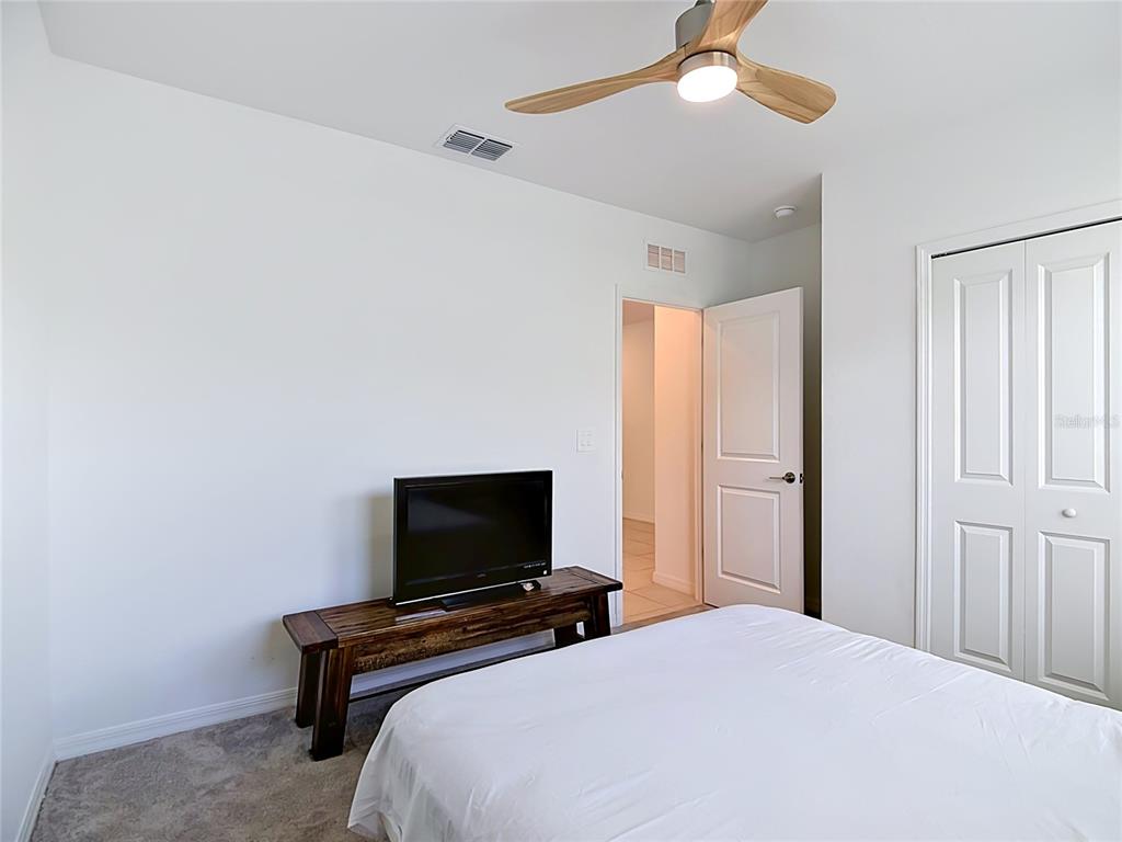 1633 Red Loop Lakeland, FL 33801 - Photo 17 of 60 a bedroom with a bed and a flat screen tv