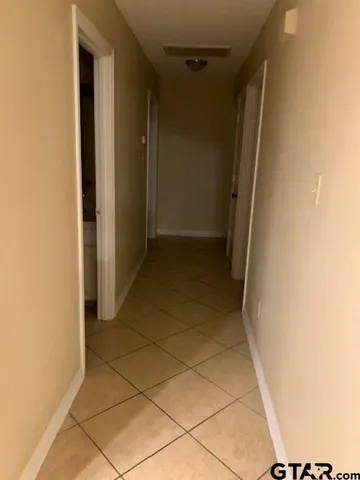 a view of a room with an empty space and a ceiling fan