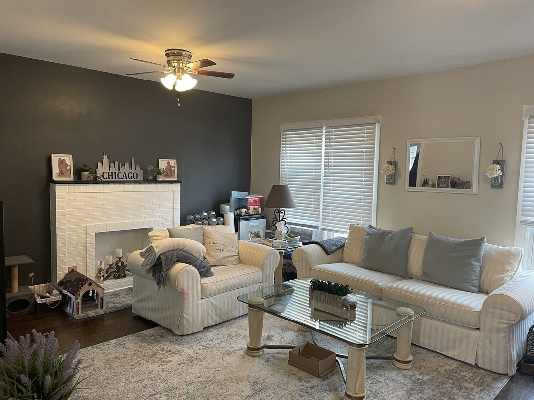 730 West Roscoe Street, Unit 2S Chicago, IL 60657 - Photo 2 of 15 a living room with furniture and a chandelier