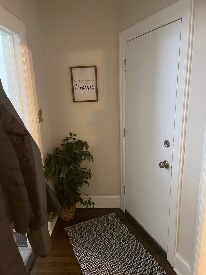 730 West Roscoe Street, Unit 2S Chicago, IL 60657 - Photo 11 of 15 a room with a black door and a window
