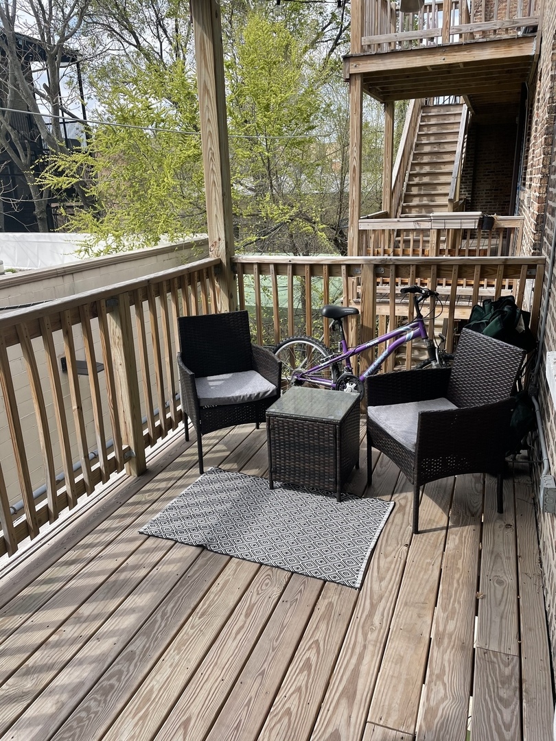 730 West Roscoe Street, Unit 2S Chicago, IL 60657 - Photo 15 of 15 a balcony with wooden floor table and chairs