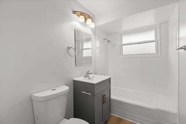 a bathroom with a sink toilet vanity and bathtub