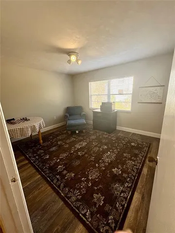a living room with a bed furniture and a window