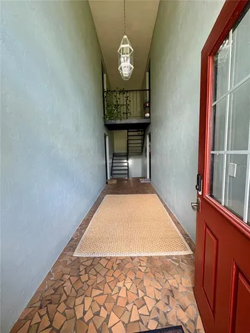 a view of a room with wooden floor and staircase