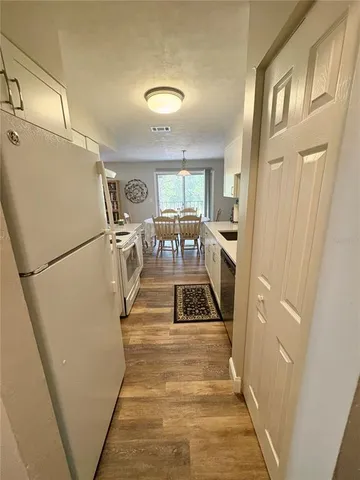 a kitchen with a stove and a white refrigerator