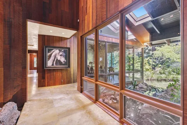 a living room with stainless steel appliances granite countertop furniture a fireplace and a large window