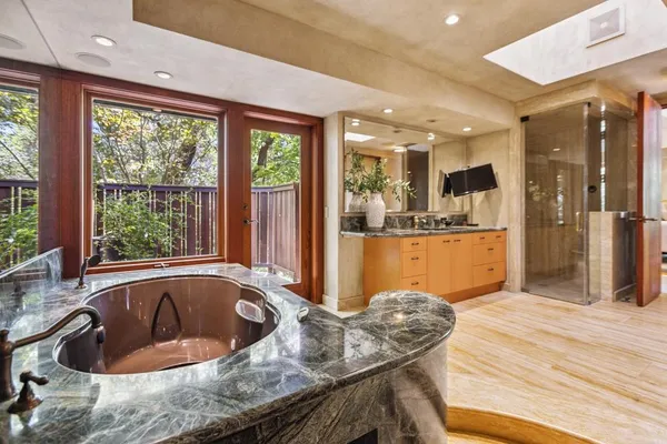 a living room with furniture a flat screen tv and a floor to ceiling window