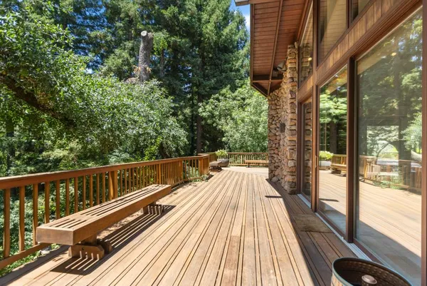 a backyard of a house with lots of green space and lake view