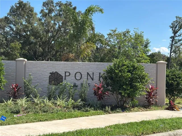 a view of a house with a yard and a bench