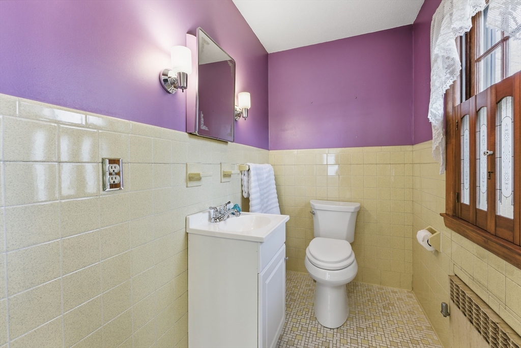 63 Webber Street Springfield, MA 01108 - Photo 14 of 40 a bathroom with a toilet a sink and mirror