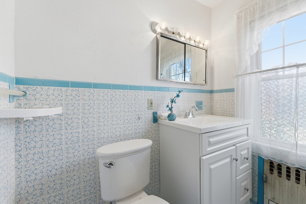 63 Webber Street Springfield, MA 01108 - Photo 29 of 40 a bathroom with a sink a toilet and mirror