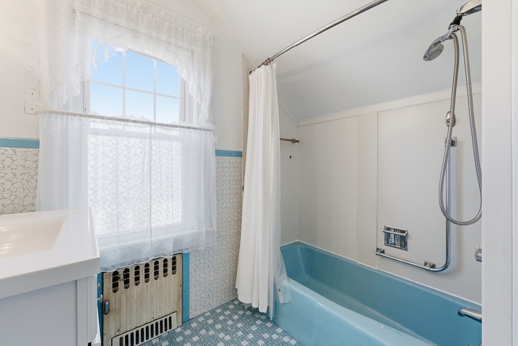 63 Webber Street Springfield, MA 01108 - Photo 30 of 40 a bathroom with a tub a sink and a shower