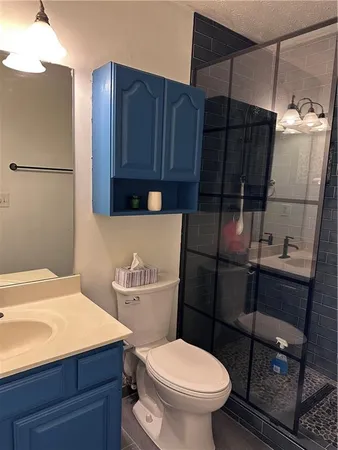 a bathroom with a toilet and a shower