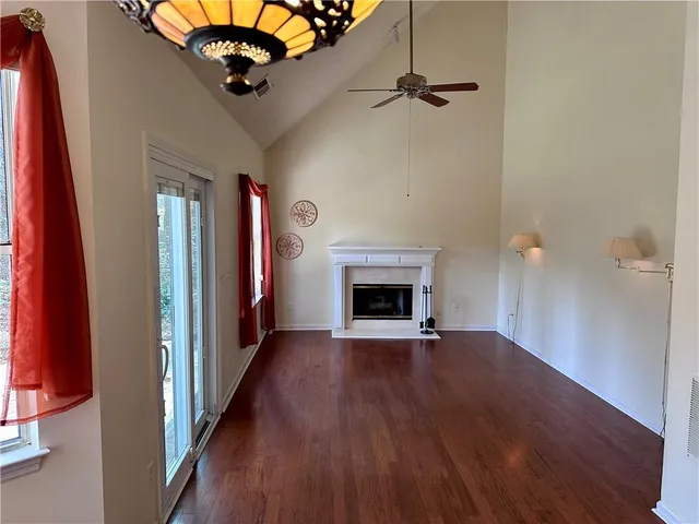 a view of a livingroom with a fireplace and wooden floor