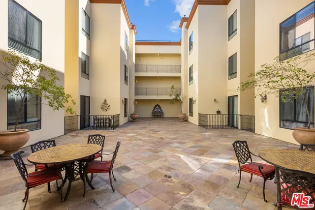 a backyard of a house with table and chairs