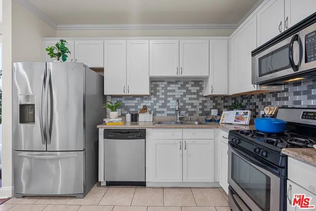 a kitchen with stainless steel appliances granite countertop a refrigerator stove a sink and dishwasher