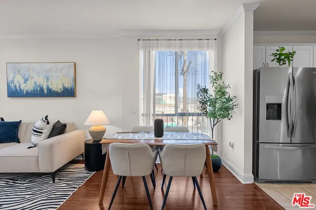 a view of a dining room with furniture window and wooden floor