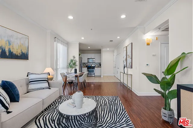 a living room with furniture a potted plant and a table