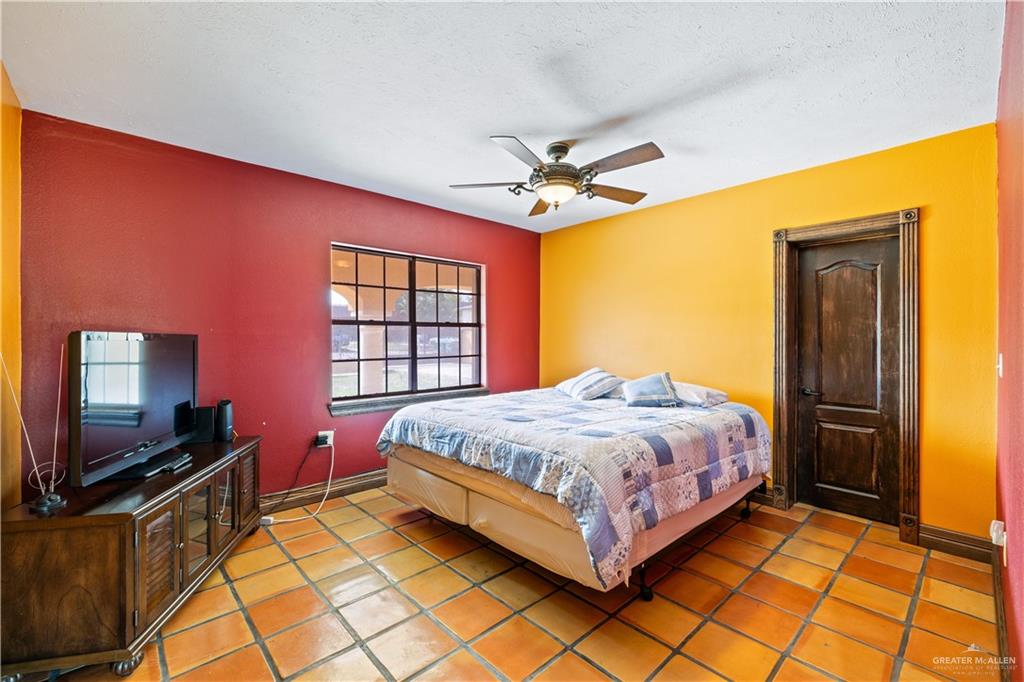 610 North Texas Street Rio Grande City, TX 78582 - Photo 15 of 23 a bedroom with a bed and a flat screen tv