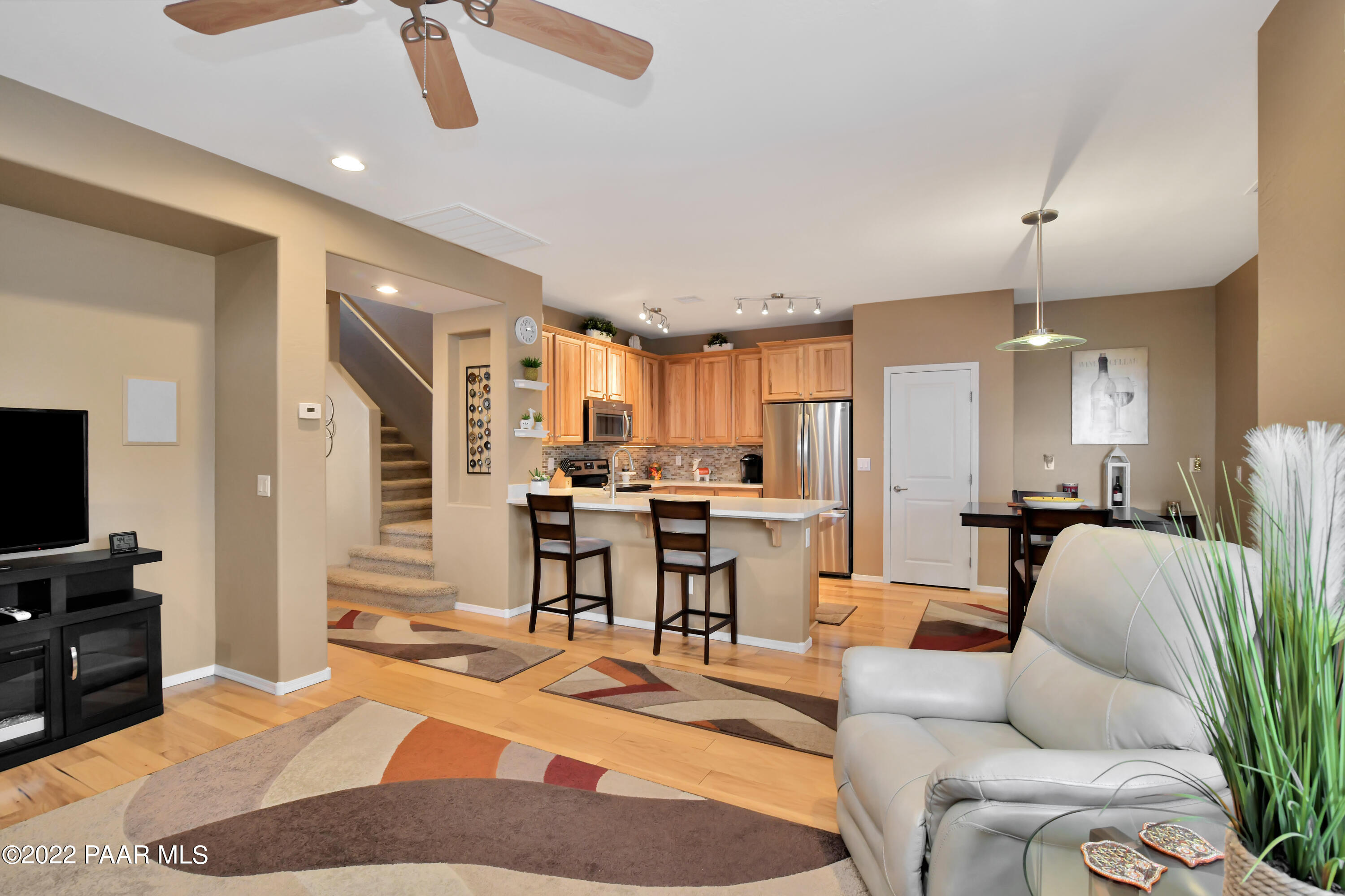 7209 Woolsey Ranch Road Prescott Valley, AZ 86314 - Photo 13 of 49 a living room with furniture kitchen view and a wooden floor