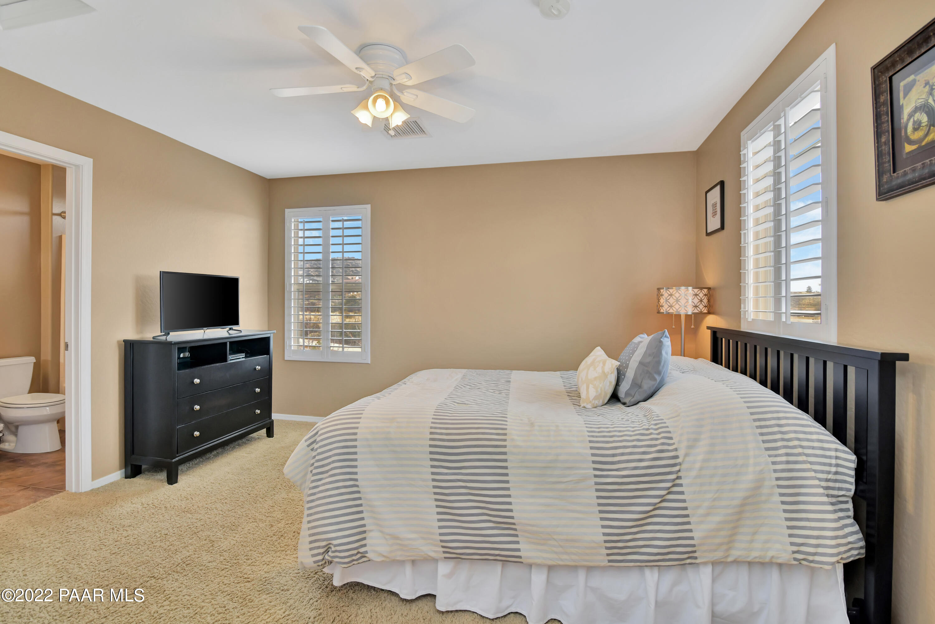 7209 Woolsey Ranch Road Prescott Valley, AZ 86314 - Photo 27 of 49 a bedroom with a bed and a flat screen tv