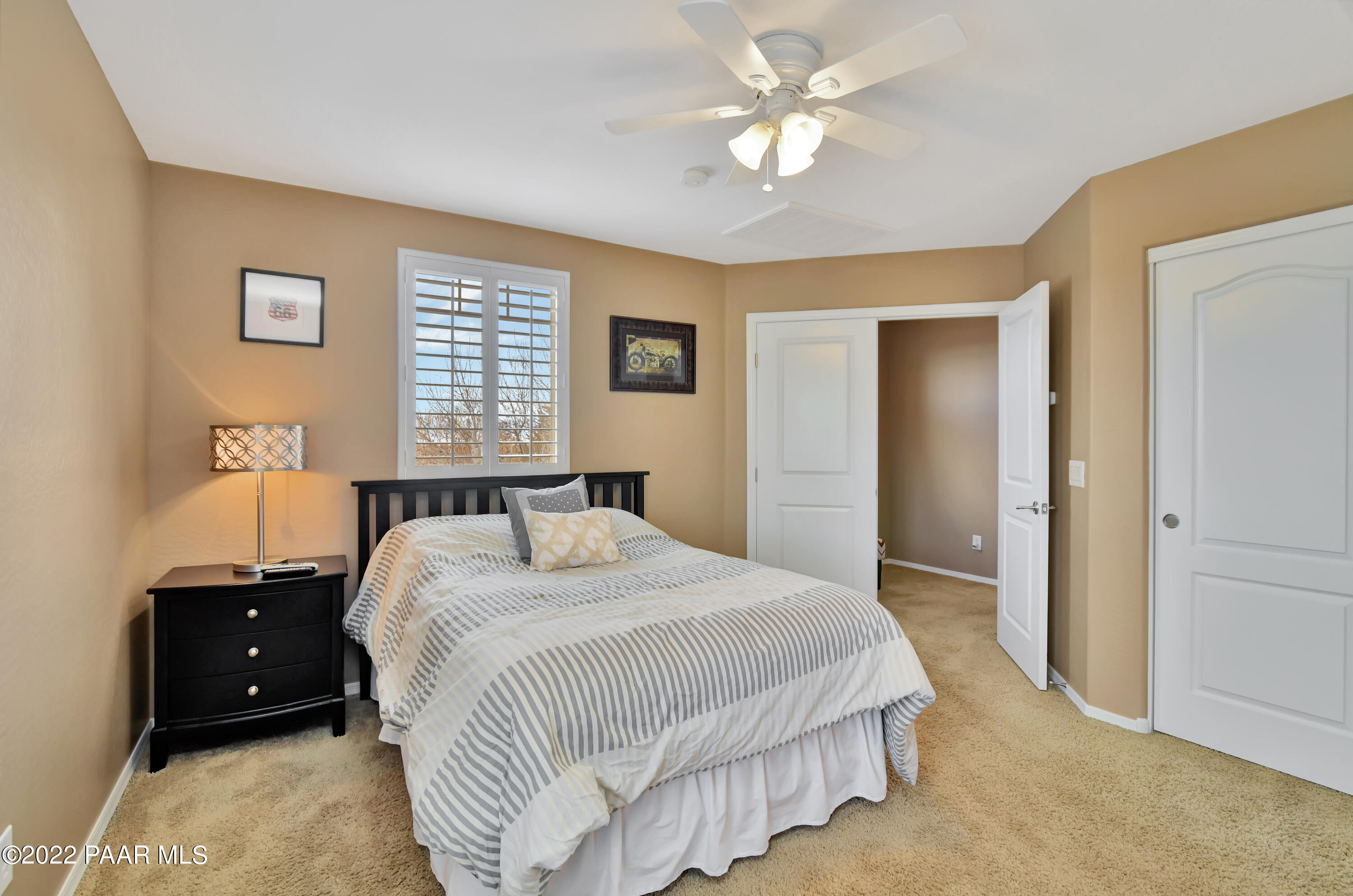 7209 Woolsey Ranch Road Prescott Valley, AZ 86314 - Photo 28 of 49 a bedroom with a bed and a chandelier