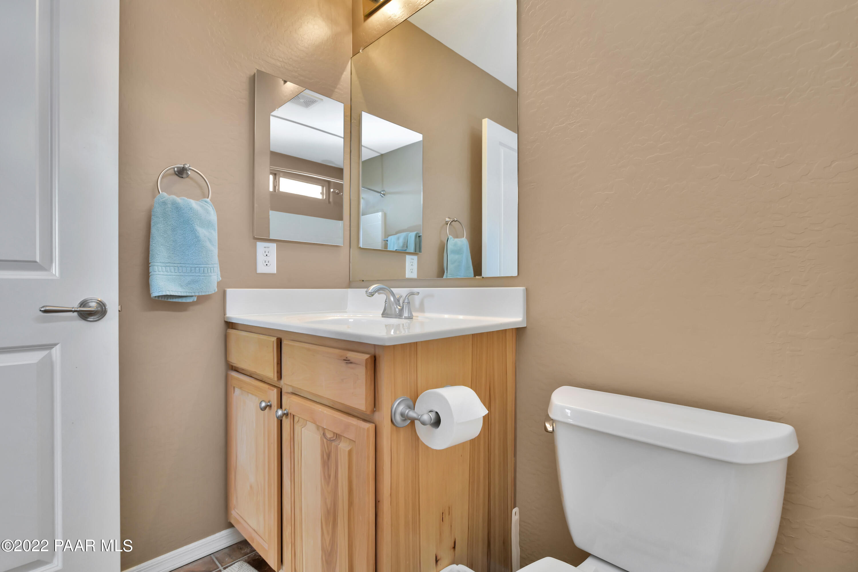 7209 Woolsey Ranch Road Prescott Valley, AZ 86314 - Photo 29 of 49 a bathroom with a sink a toilet and a mirror