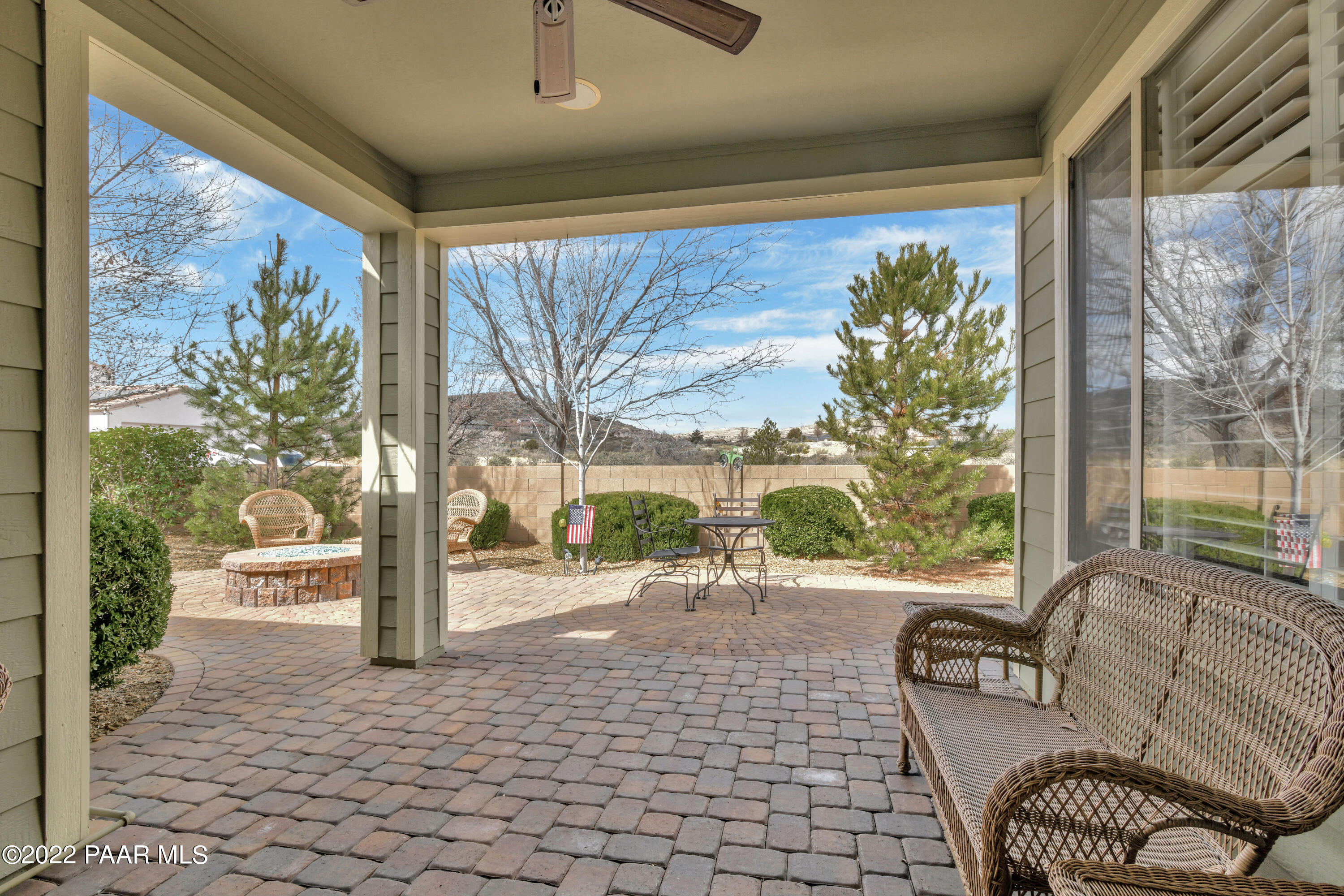 7209 Woolsey Ranch Road Prescott Valley, AZ 86314 - Photo 33 of 49 a living room with patio furniture and a floor to ceiling window