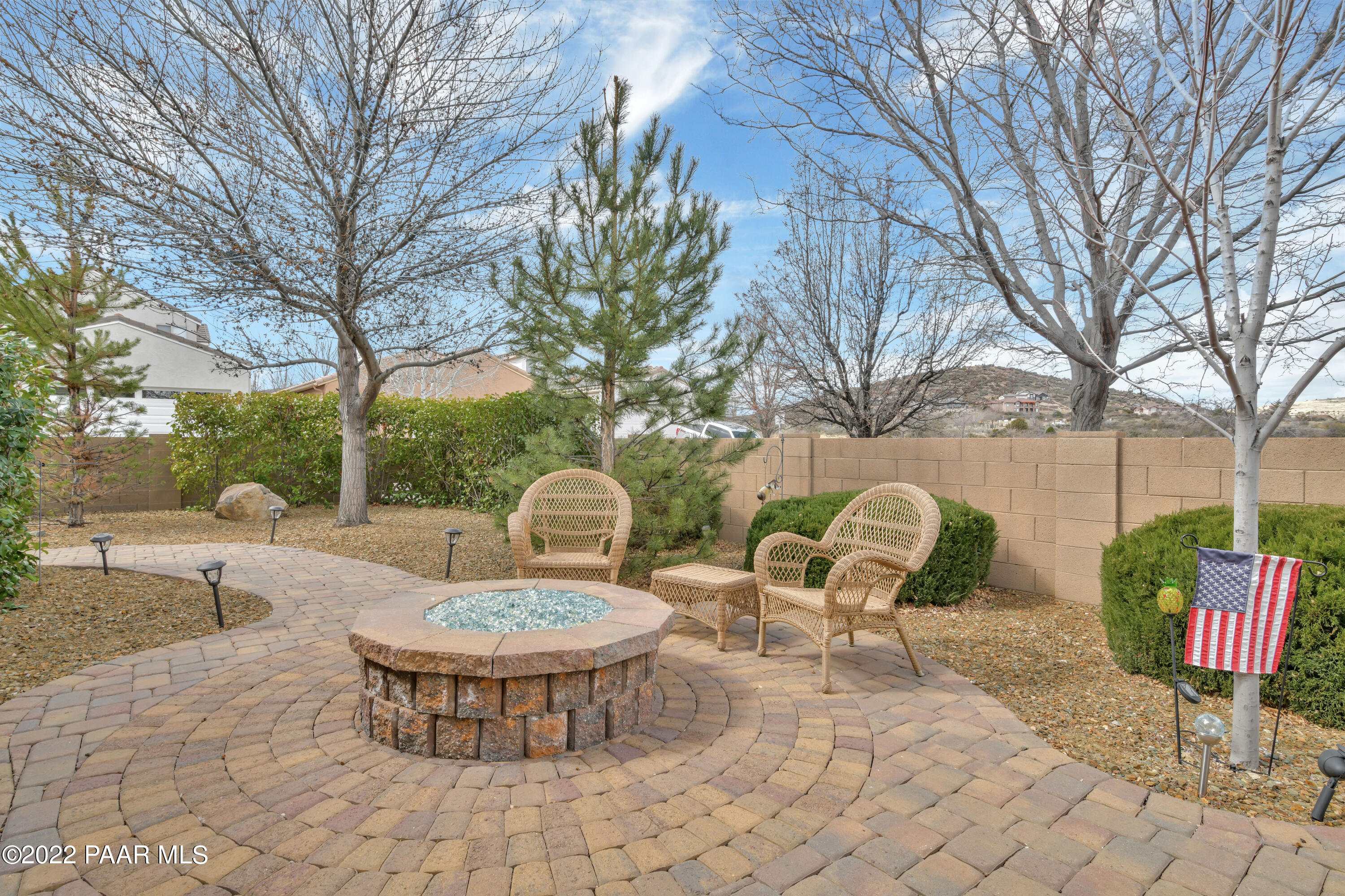 7209 Woolsey Ranch Road Prescott Valley, AZ 86314 - Photo 34 of 49 a view of a chairs and table in backyard