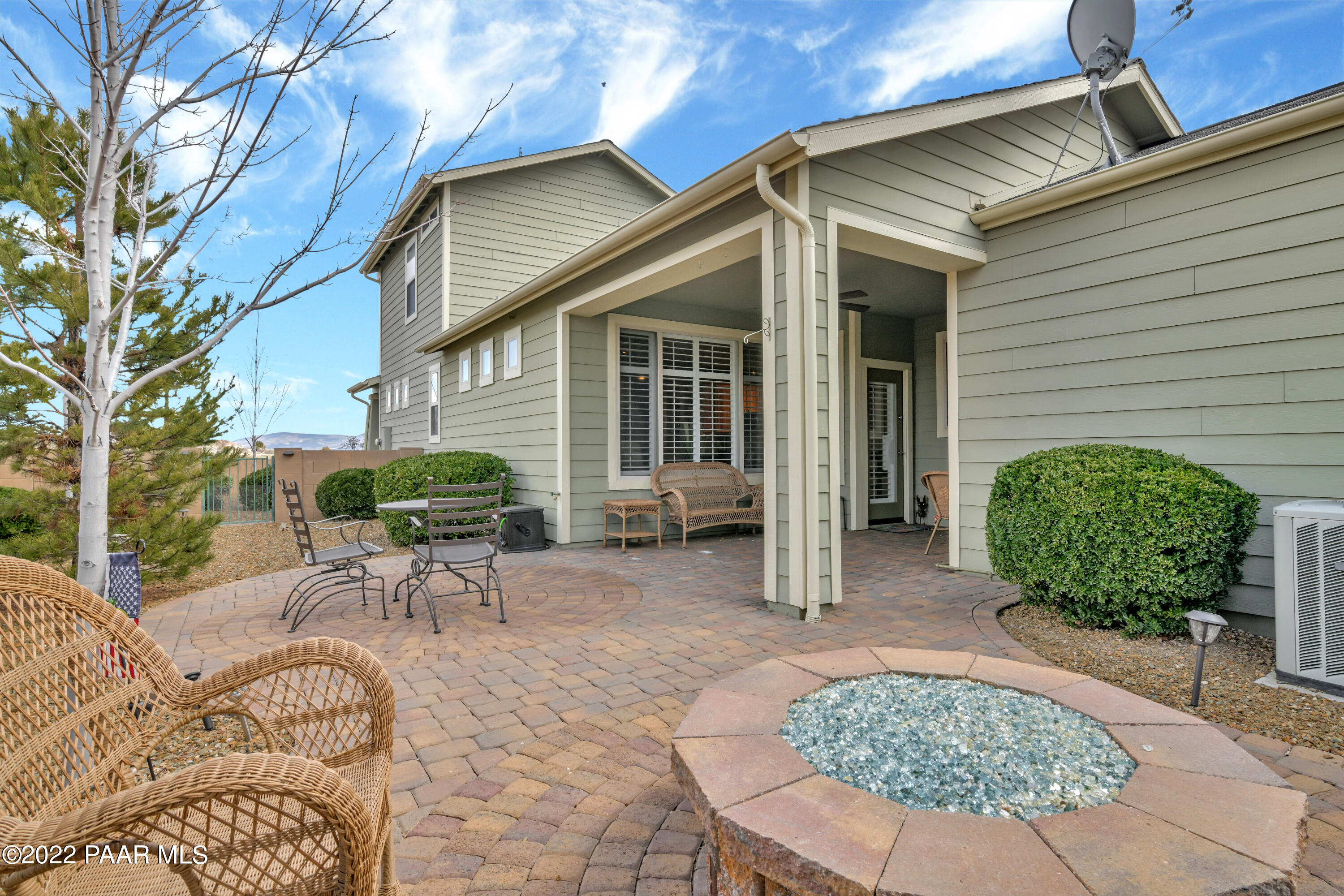 7209 Woolsey Ranch Road Prescott Valley, AZ 86314 - Photo 35 of 49 a view of a patio with table and chairs with wooden fence and plants