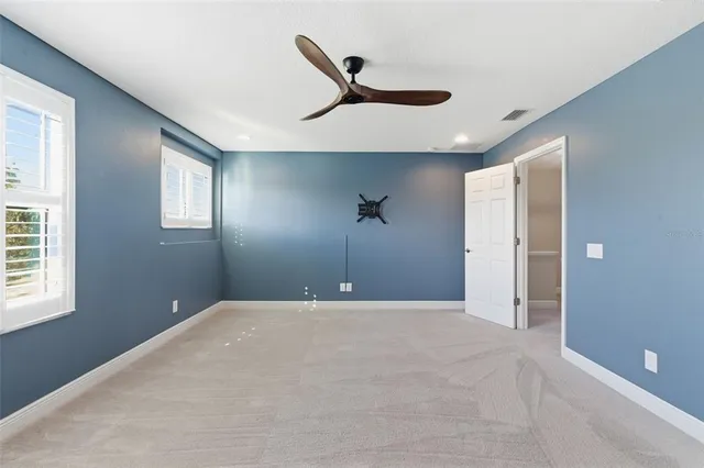 a bathroom with a granite countertop sink a mirror and shower
