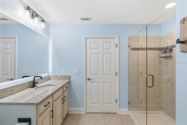 a bathroom with a granite countertop toilet a sink and a mirror