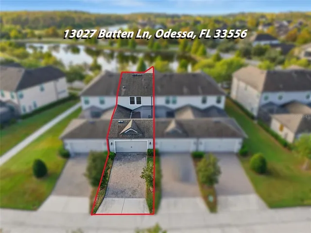 an aerial view of a house with a yard and garden