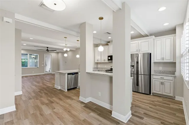 a kitchen with a refrigerator and a sink