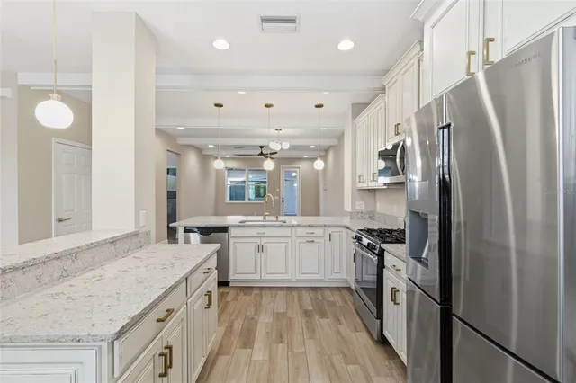 a kitchen with a sink stove and refrigerator