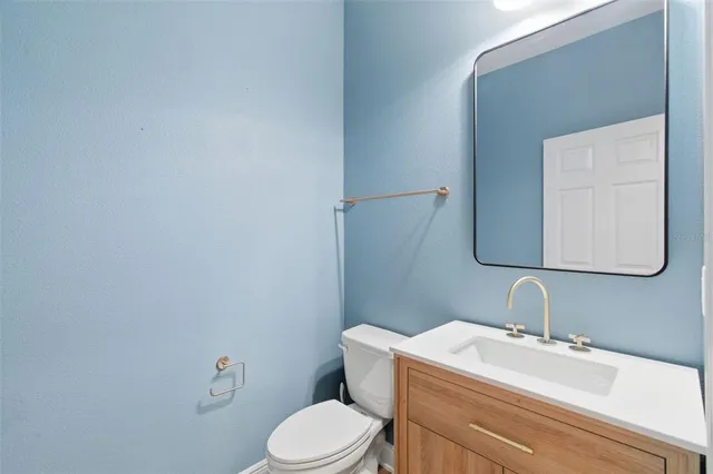 a white toilet sitting next to a bathroom sink