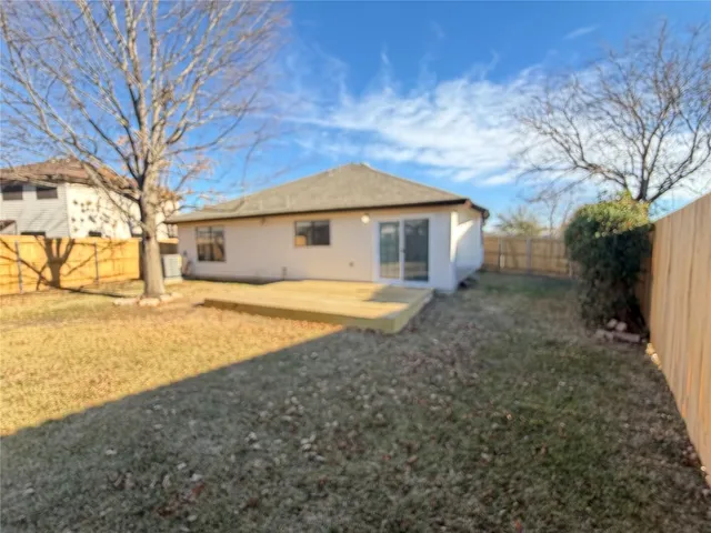 a white house that has a tree in front of it