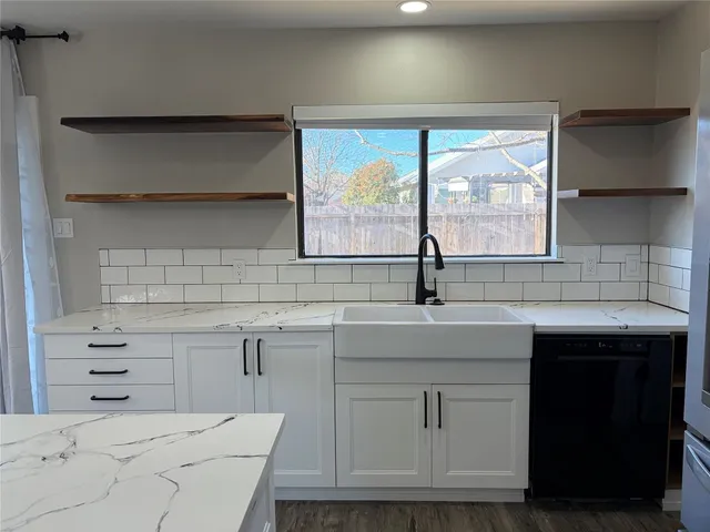 a kitchen with a sink and cabinets