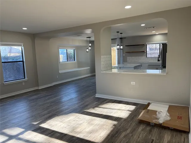 a room with wooden floor and window