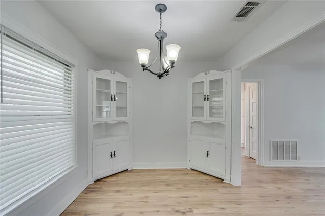 a kitchen with stainless steel appliances white cabinets and a stove top oven