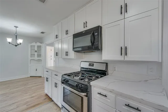 a kitchen with appliances cabinets and a sink