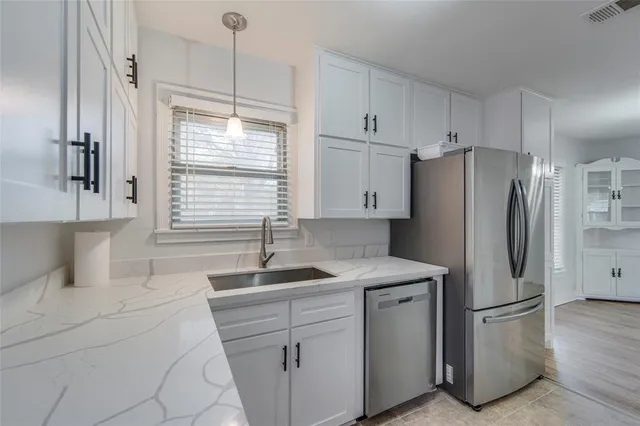 a view of a room with wooden floor and a ceiling fan