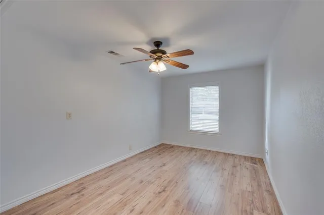 a bathroom with a sink toilet vanity and granite