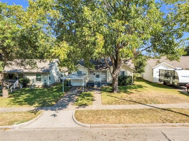 a view of a trees and front view of a house