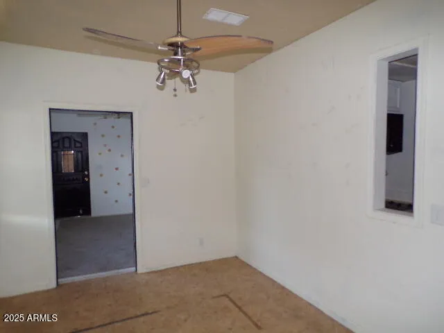 an empty room and chandelier fan