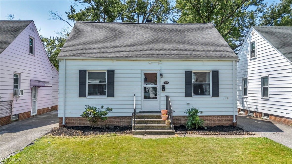 21100 Watson Road Maple Heights, OH 44137 - Photo 1 of 37 View of front of property with entry steps, a shingled roof, a front yard