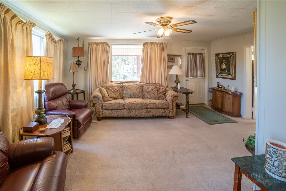 292 Little Elk Road Elk Park, NC 28622 - Photo 11 of 28 a living room with furniture and a large window