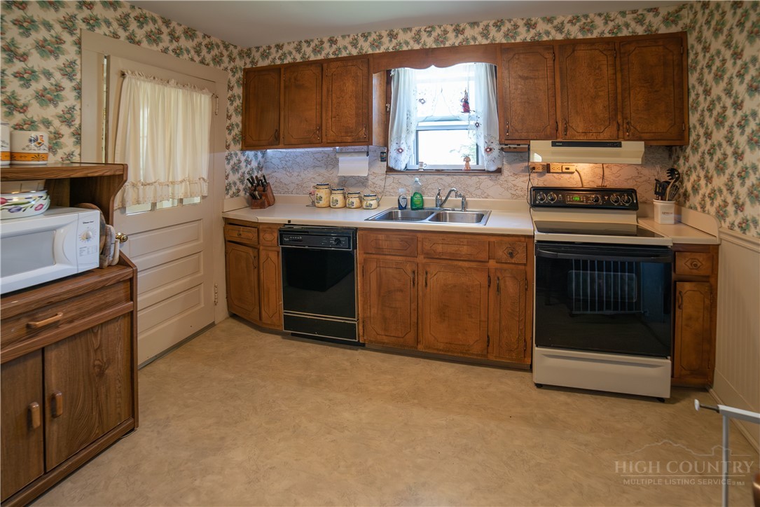 292 Little Elk Road Elk Park, NC 28622 - Photo 14 of 28 a kitchen with a sink stove and cabinets