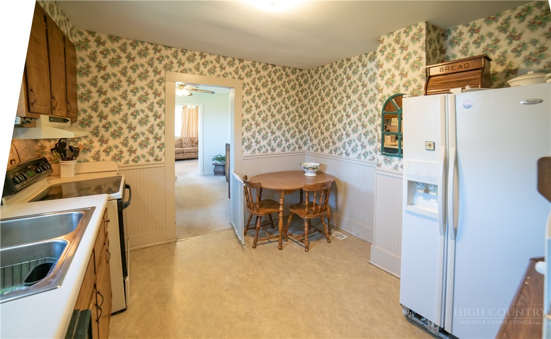292 Little Elk Road Elk Park, NC 28622 - Photo 15 of 28 a dining room with furniture and a refrigerator