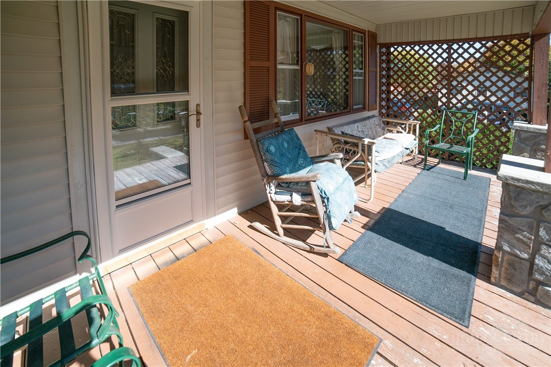 292 Little Elk Road Elk Park, NC 28622 - Photo 3 of 28 a view of a patio with table and chairs and wooden floor